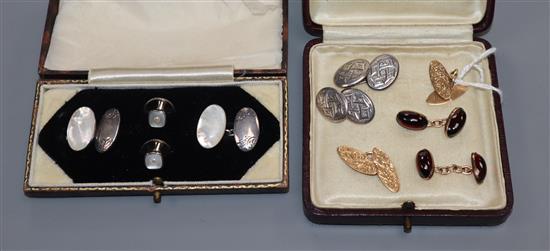 A pair of 15ct gold navette-shaped cufflinks, a garnet-set pair, a silver pair and a silver and mother of pearl dress set, cased